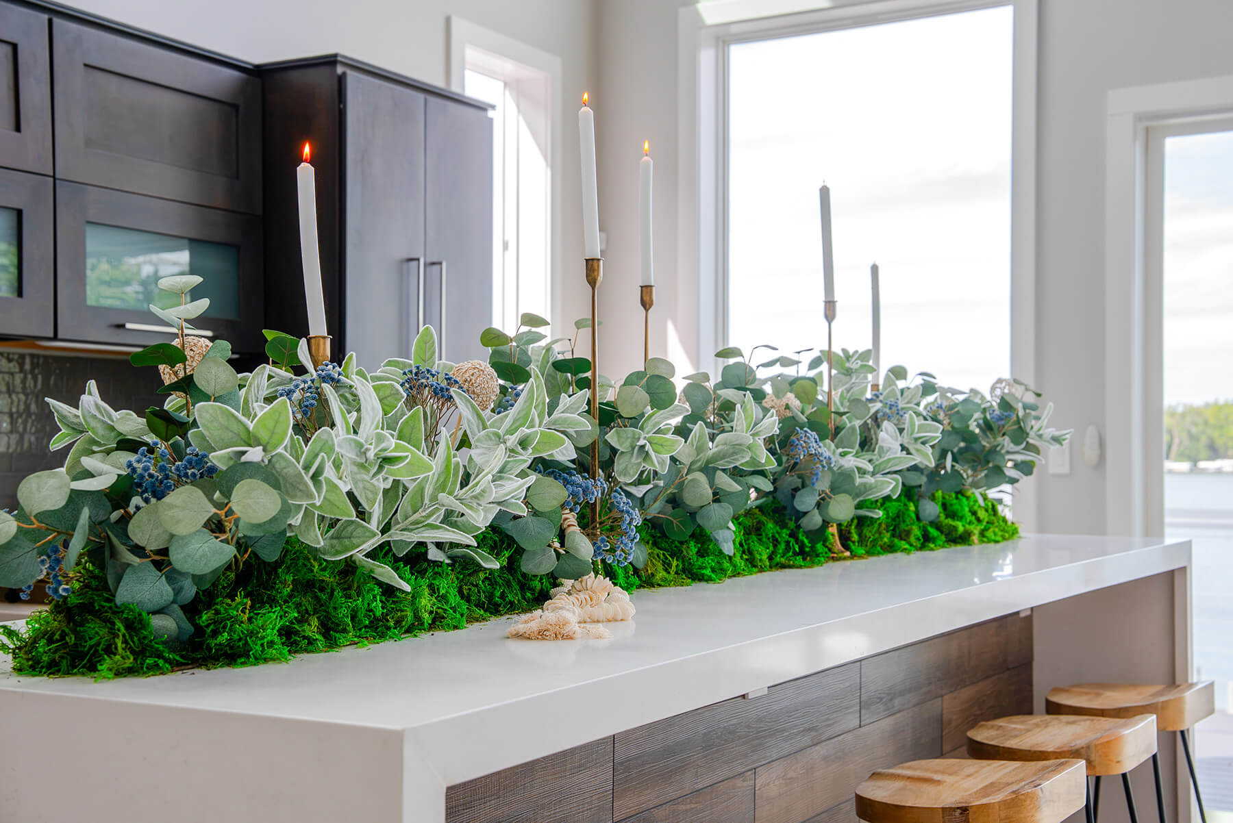 Okoboji-Lake-House-10 Convenient drink station with bar seating decorated with lush greenery and gold taper candle holders