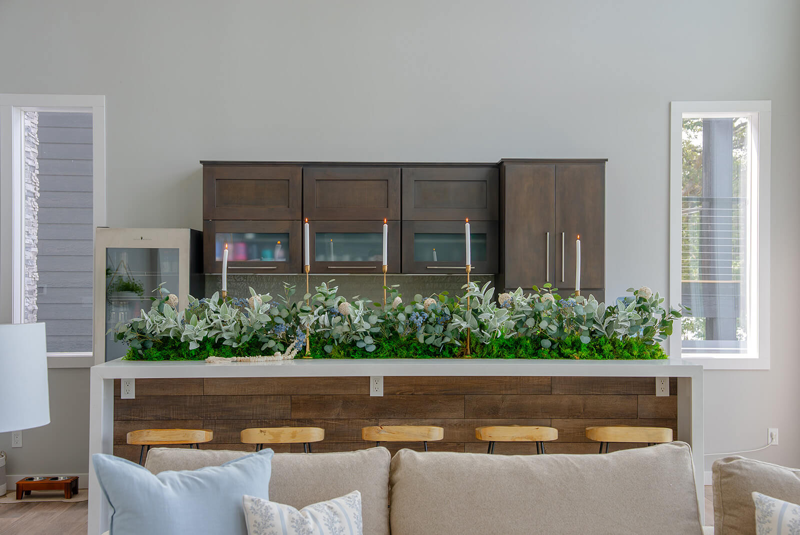 Okoboji-Lake-House-11 Dark wood console, sculptural decor, and lush greenery against a clean neutral backdrop