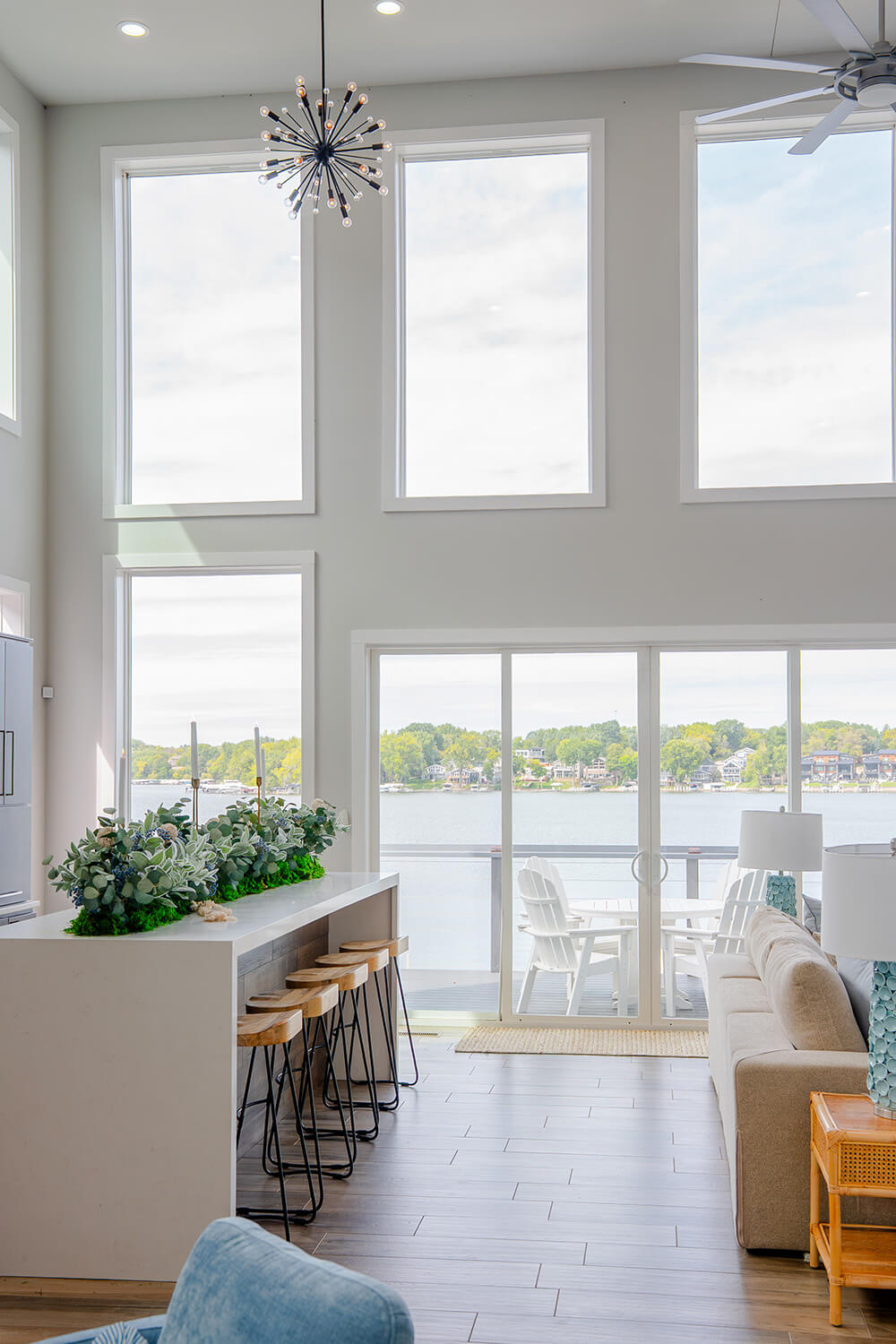 Okoboji-Lake-House-12 Dramatic floor-to-ceiling windows fill this Okoboji Lake House interior with natural light and create a bright, airy design aesthetic