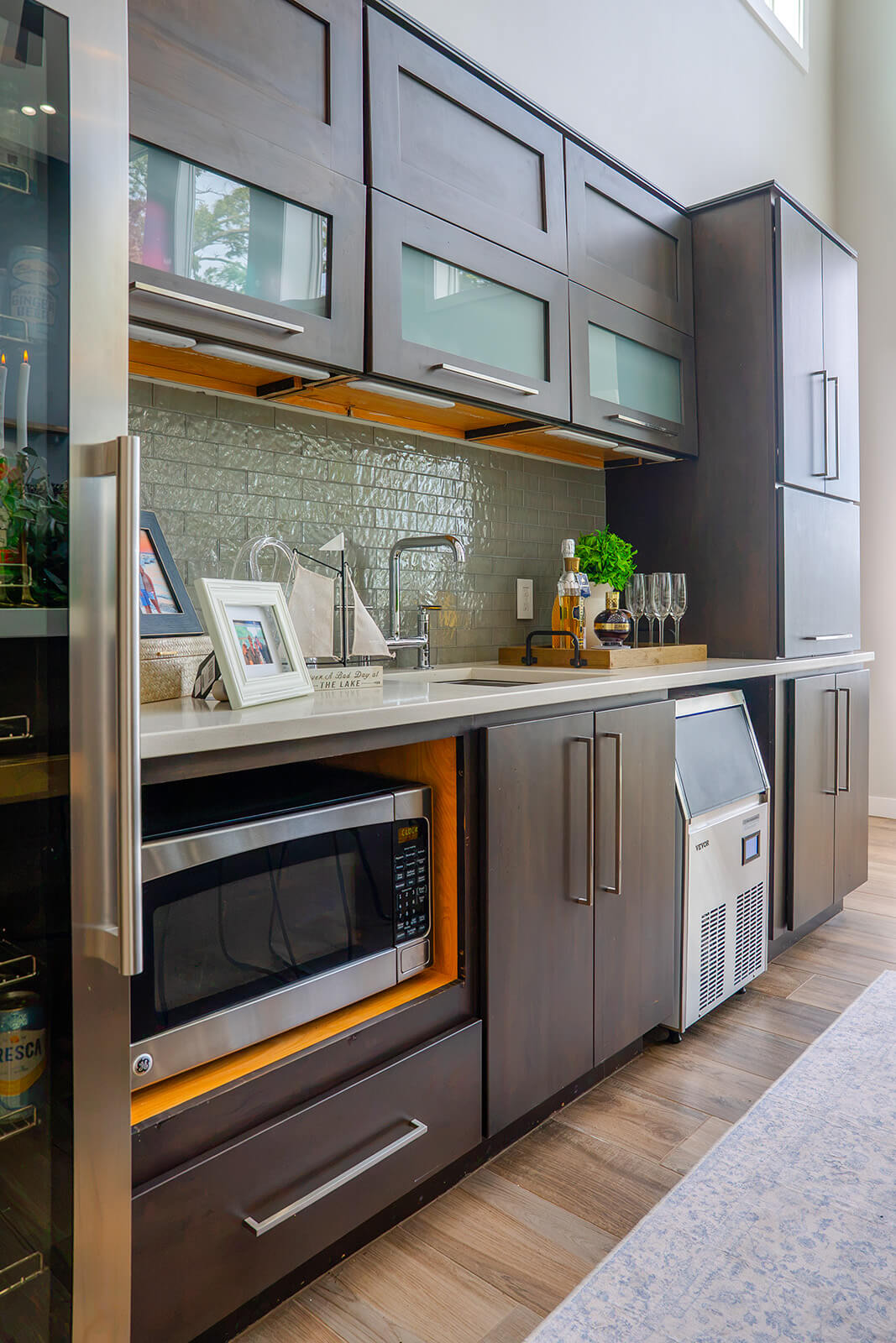 Okoboji-Lake-House-13 Elevated kitchen designed with dark cabinetry, open shelving and natural wood accents