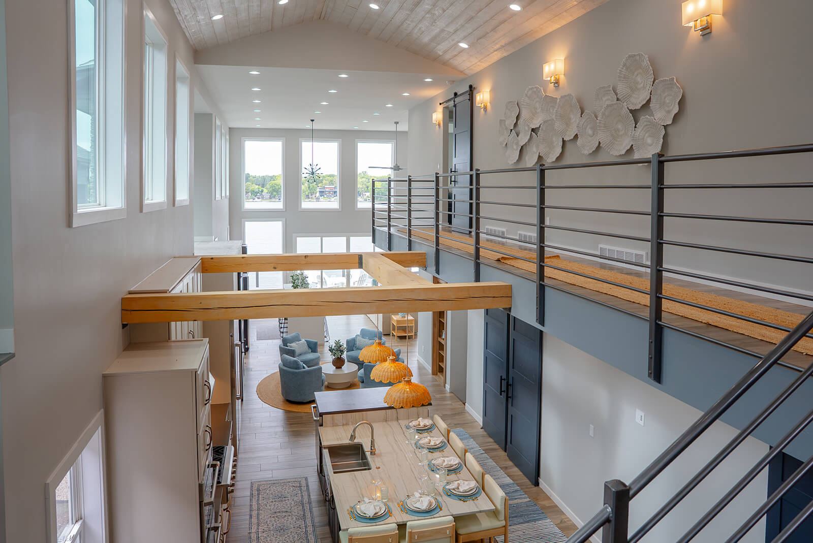 Okoboji-Lake-House-31 Bright, airy interior with an open staircase and natural wood railings creating a clean, contemporary feel