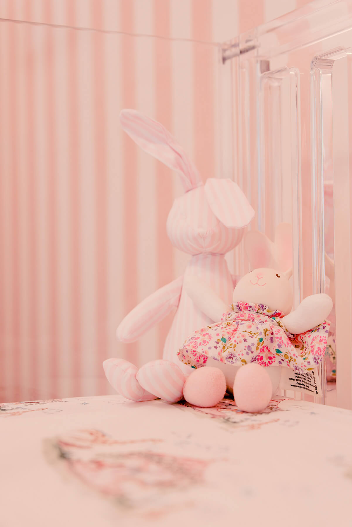 Storybook-14 Whimsical nursery vignette with soft pink textiles, plush toys, and delicate layered decorative details