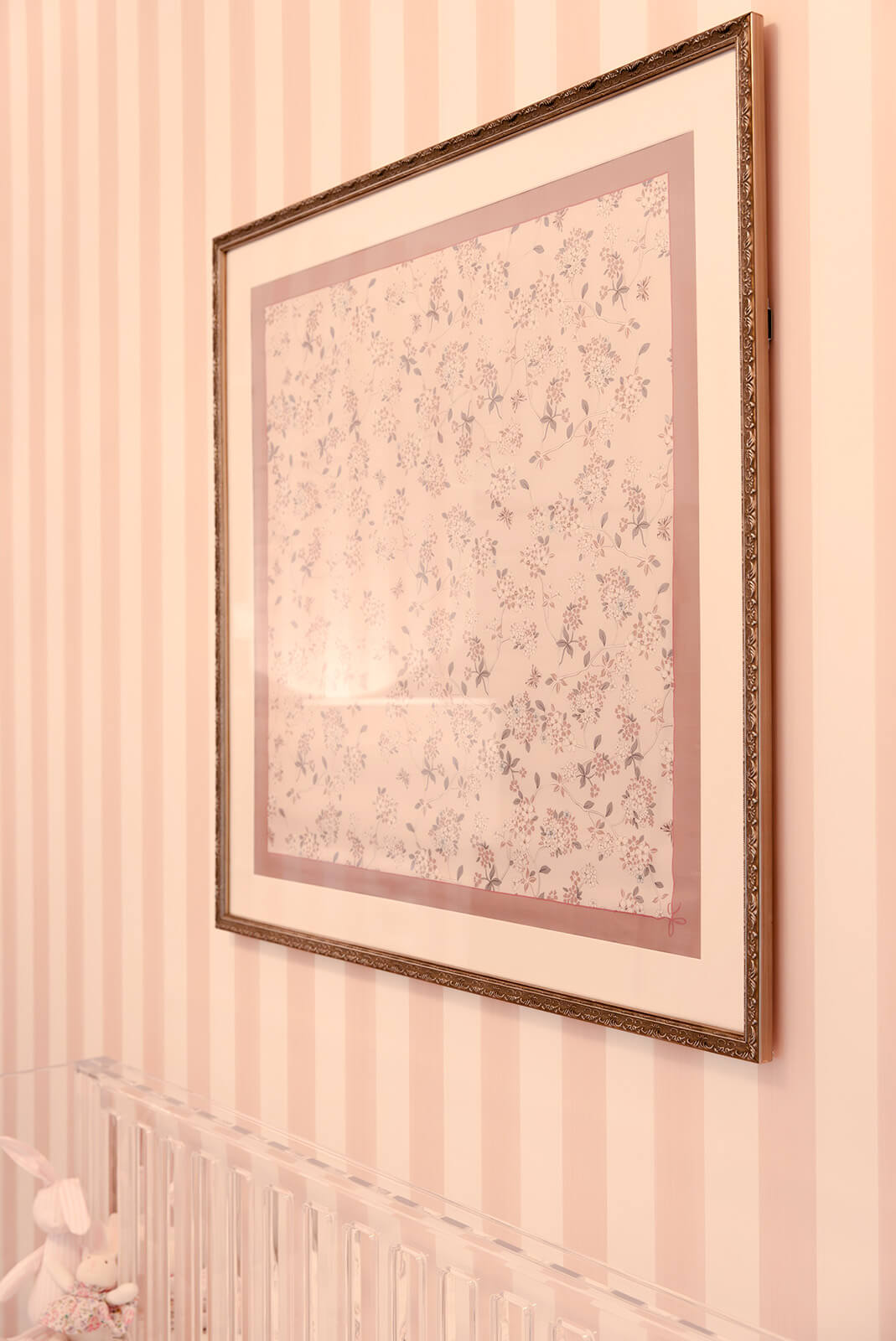 Storybook-19 Close-up of delicate pink striped wall treatment creating a soft, refined backdrop for the nursery