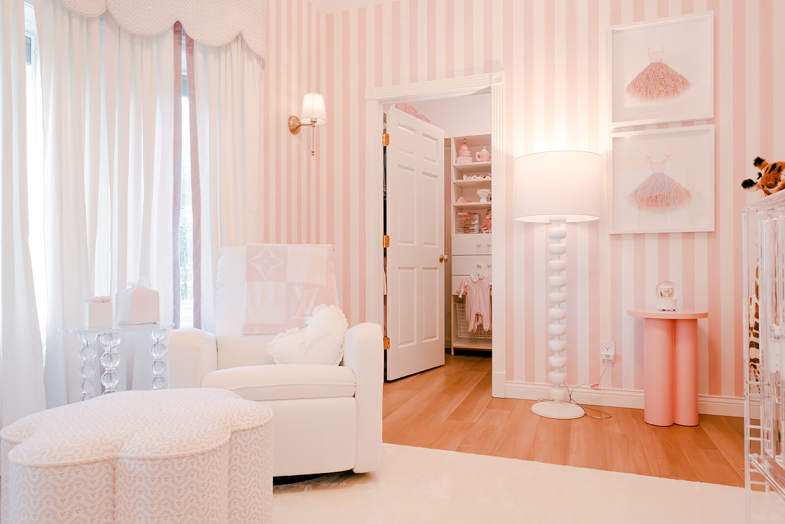 Storybook-2 Bright pink nursery with white furniture, delicate decor, and soft natural light filtering through sheer curtains