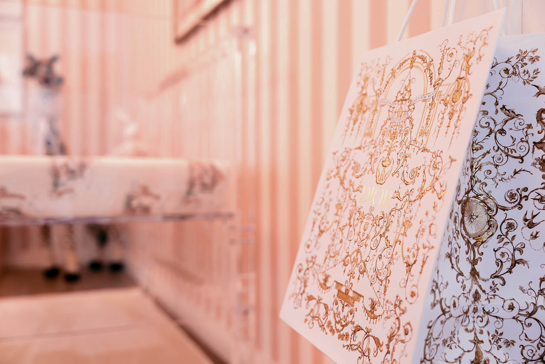 Storybook-22 Delicate floral textile and soft pink furnishings create a romantic, layered nursery vignette