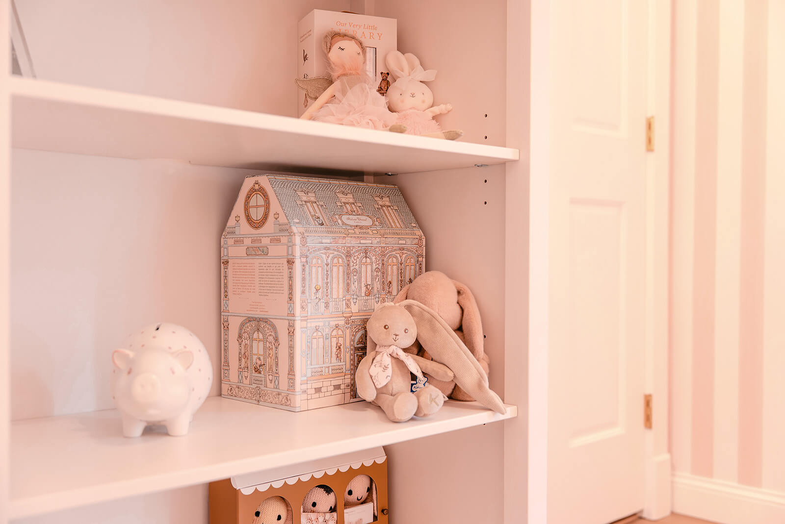 Storybook-23 Built-in nursery shelving styled with soft toys, books, and delicate decorative accessories