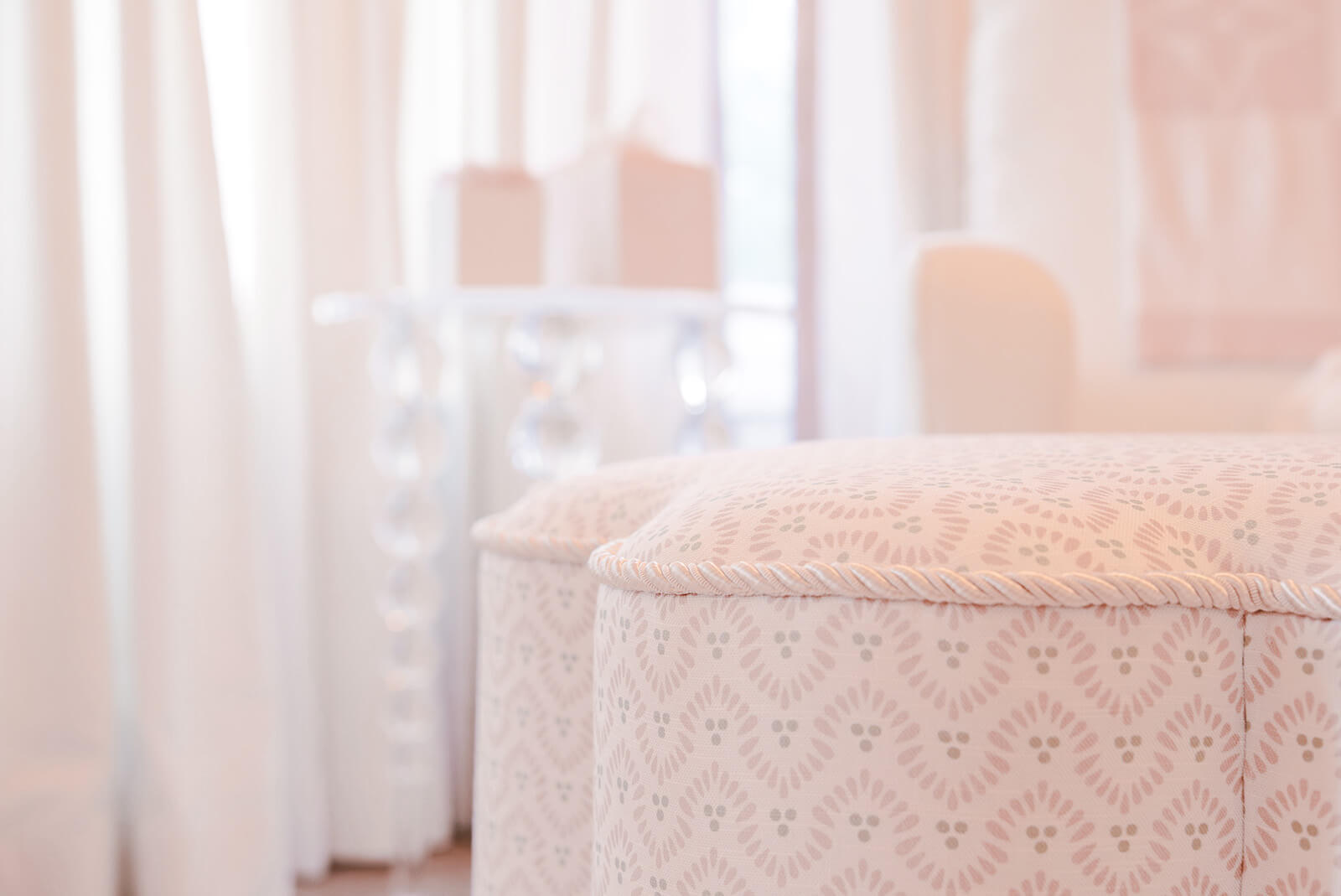 Storybook-25 Soft upholstered nursery chair framed by sheer curtains and natural light for a serene, feminine feel