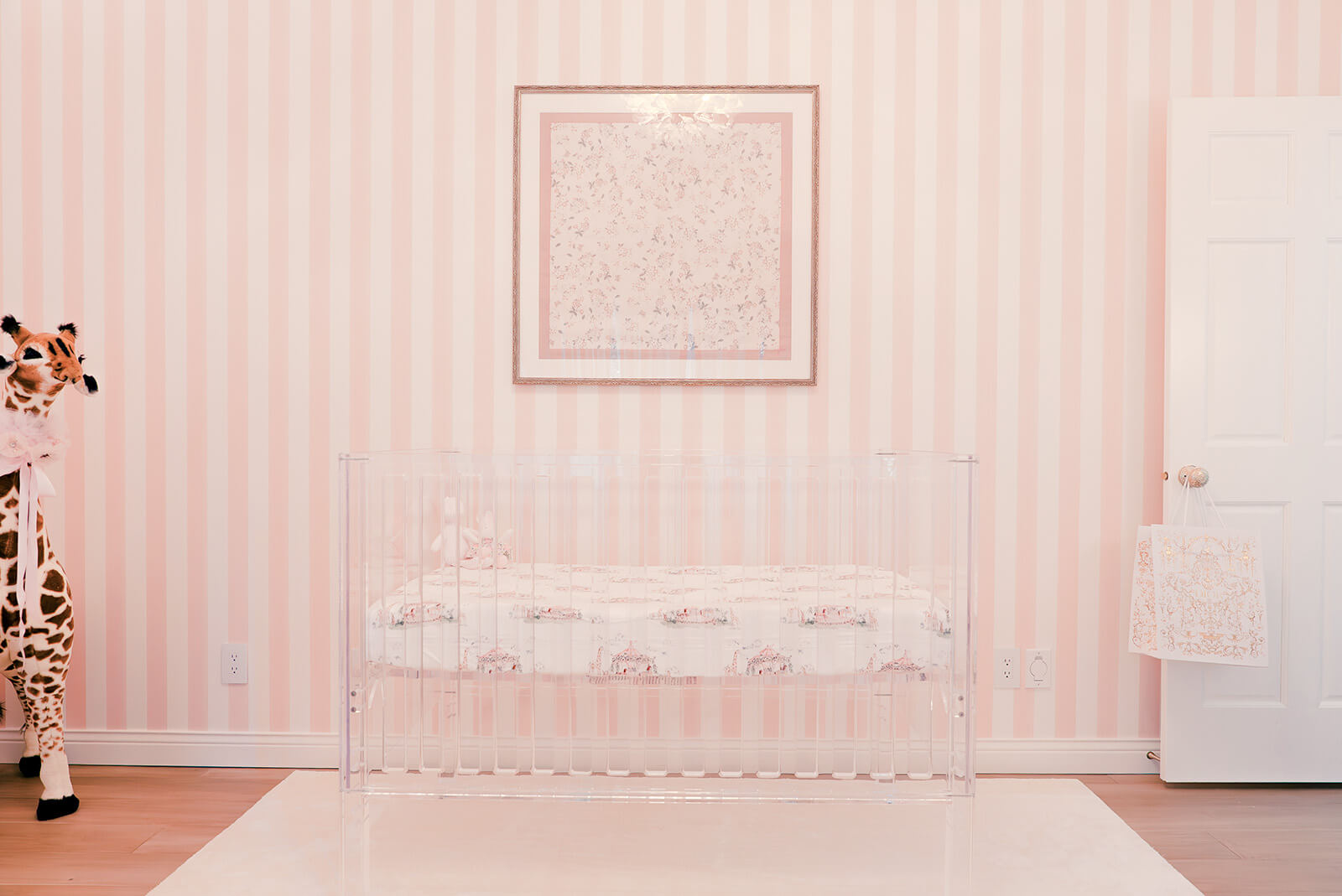 Storybook-27 Refined nursery wall featuring delicate framed artwork above a soft upholstered bench