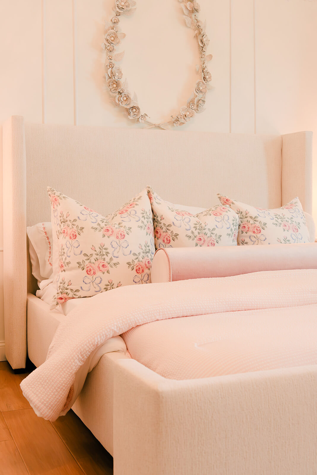 Storybook-30 Romantic bedroom seating area with a blush sofa, floral pillows, and softly layered feminine textures