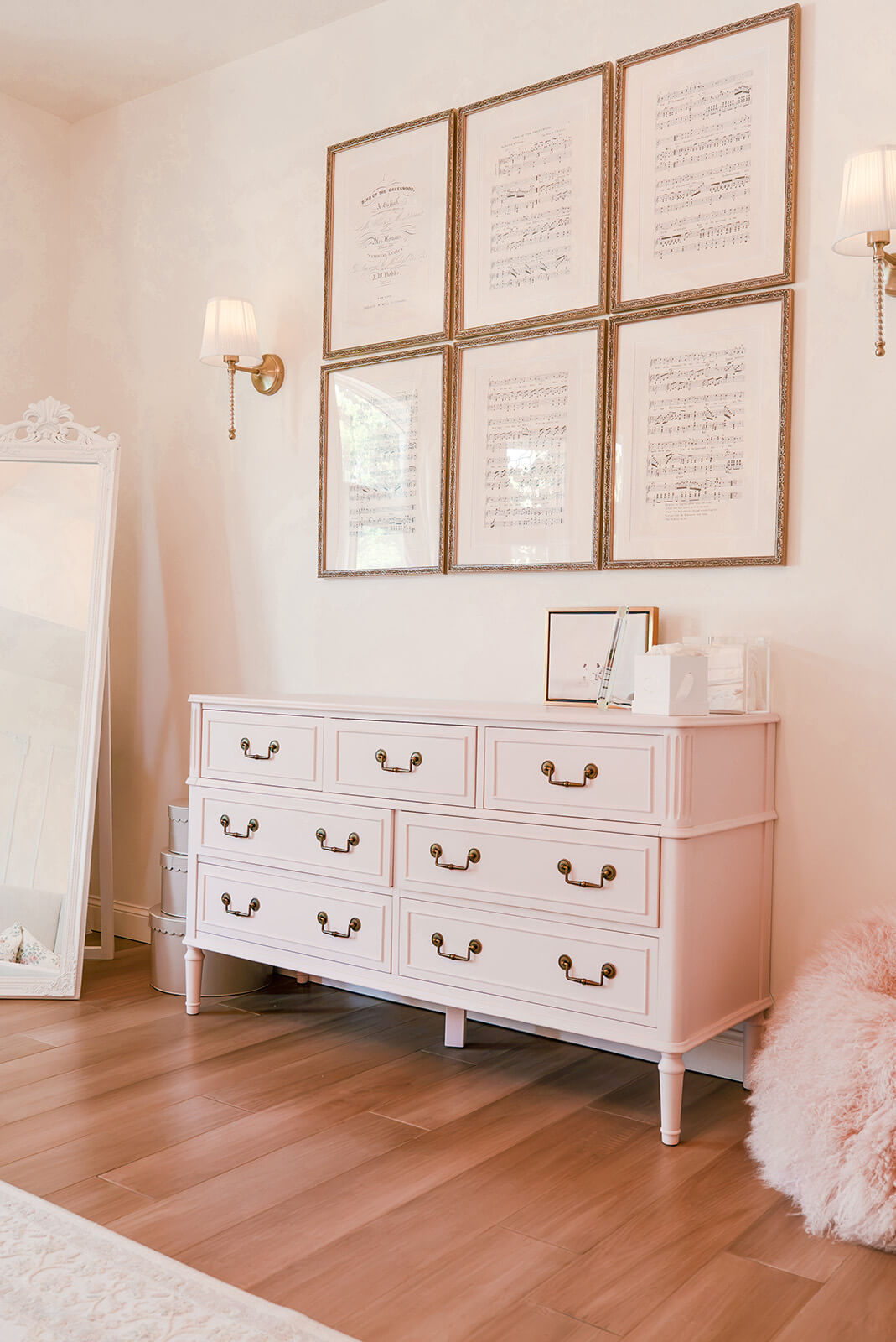 Storybook-34 Refined bedroom dresser styled with framed artwork, decorative objects, and soft neutral furnishings