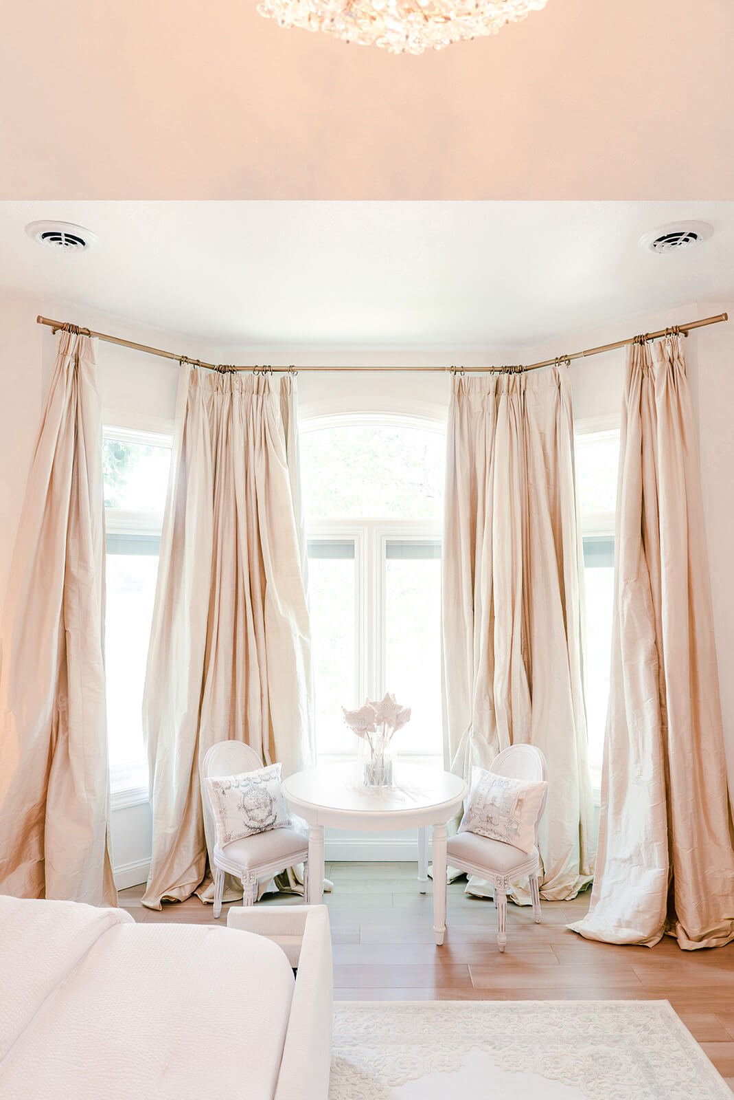 Storybook-37 Airy bedroom with expansive windows, flowing neutral curtains, and soft natural light throughout the space