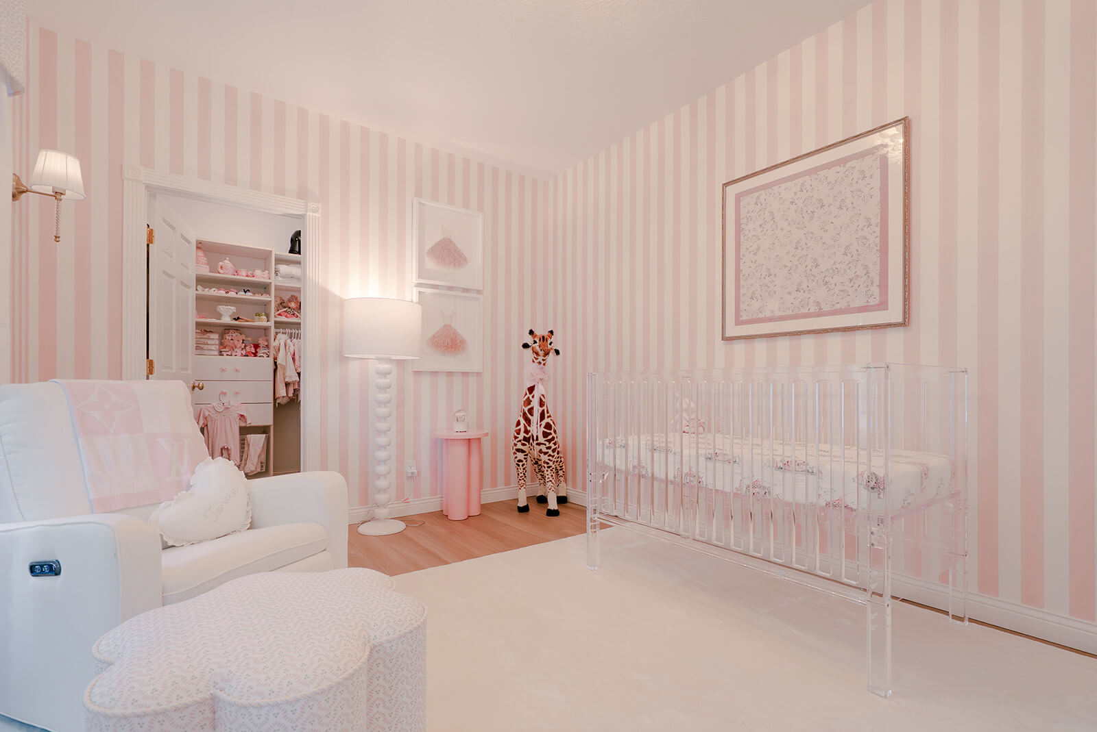 Storybook-7 Serene nursery with a white crib, blush pink walls, delicate artwork, and understated decorative accents