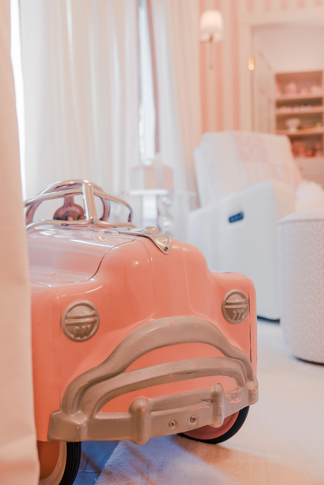 Storybook-8 Vintage-inspired pink toy car adding a playful touch to the whimsical nursery design