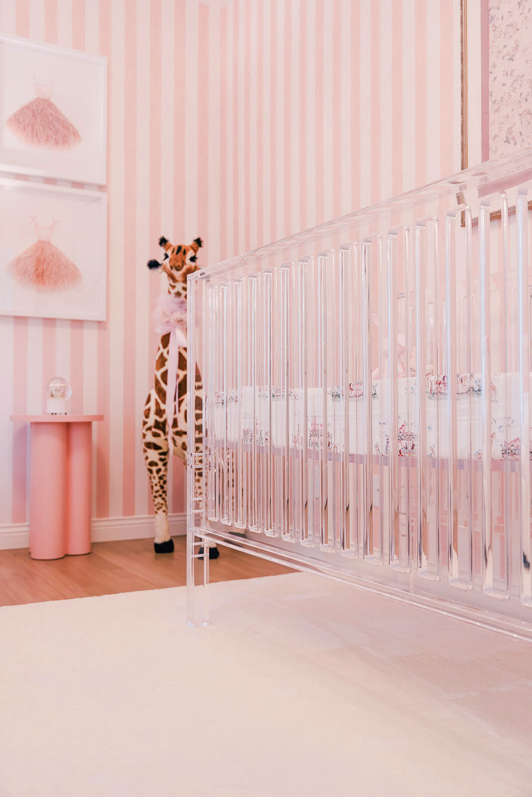 Storybook-9 Whimsical nursery corner with a tall giraffe sculpture, pink striped walls, and playful decorative accents