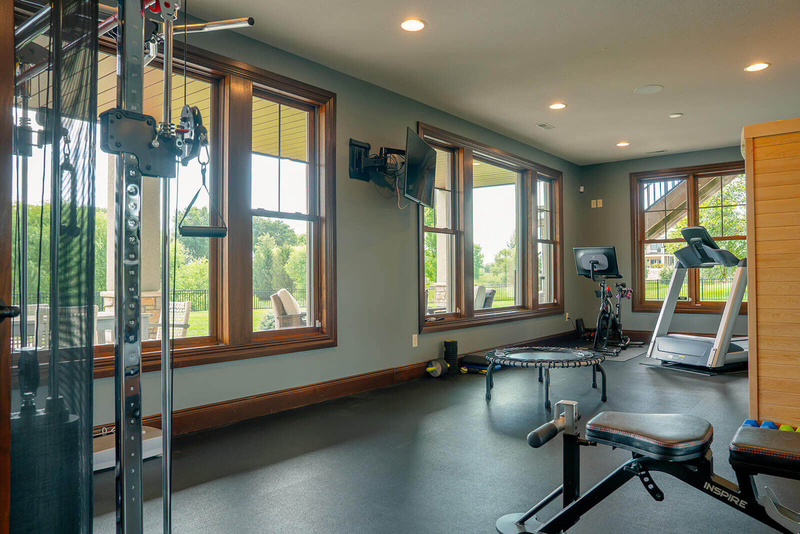 taylor-jane-project-12 Light-filled home gym with expansive windows, natural wood details, and a refined, inviting atmosphere
