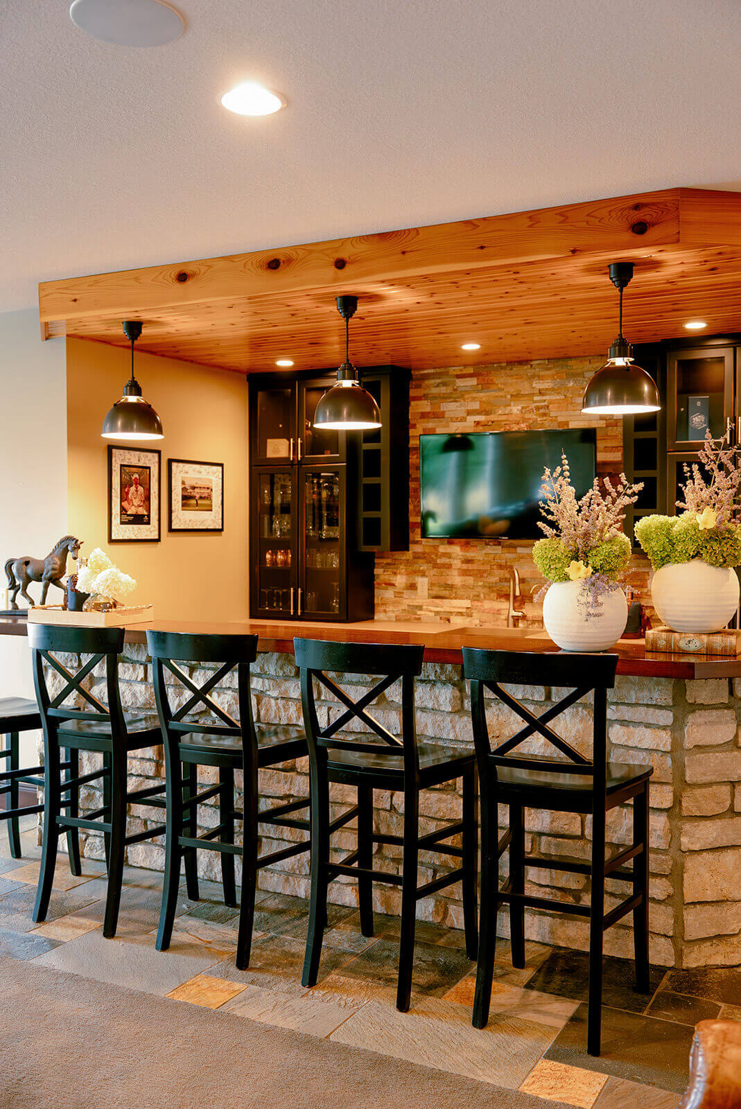 taylor-jane-project-13 Rustic dining area with wood-paneled ceiling, leather seating, and a large natural wood table