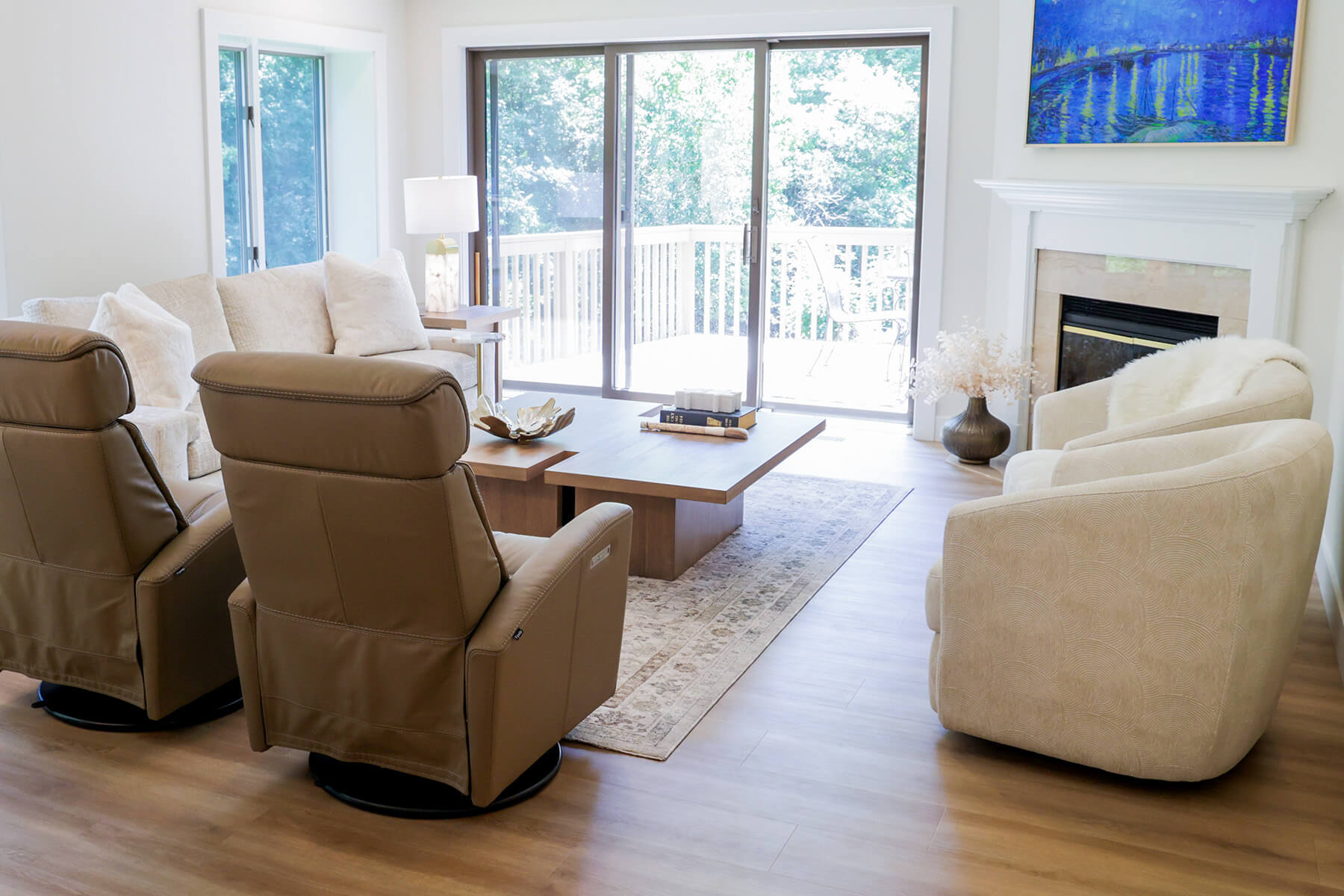 the-fairway-project-14 Thoughtfully designed living area with fireplace mantel, framed TV, and varied seating