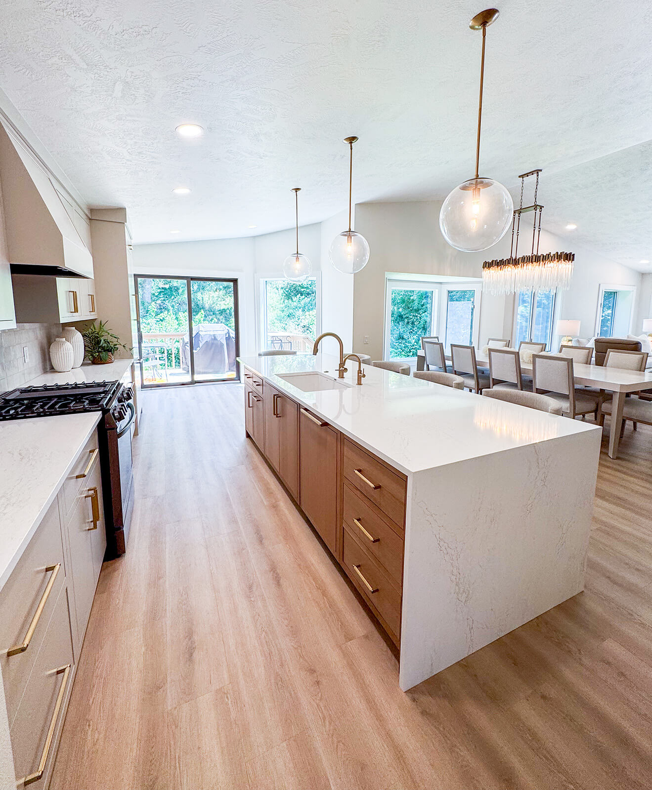 the-fairway-project-20 Elegant kitchen with white cabinetry, gold hardware, and a spacious island