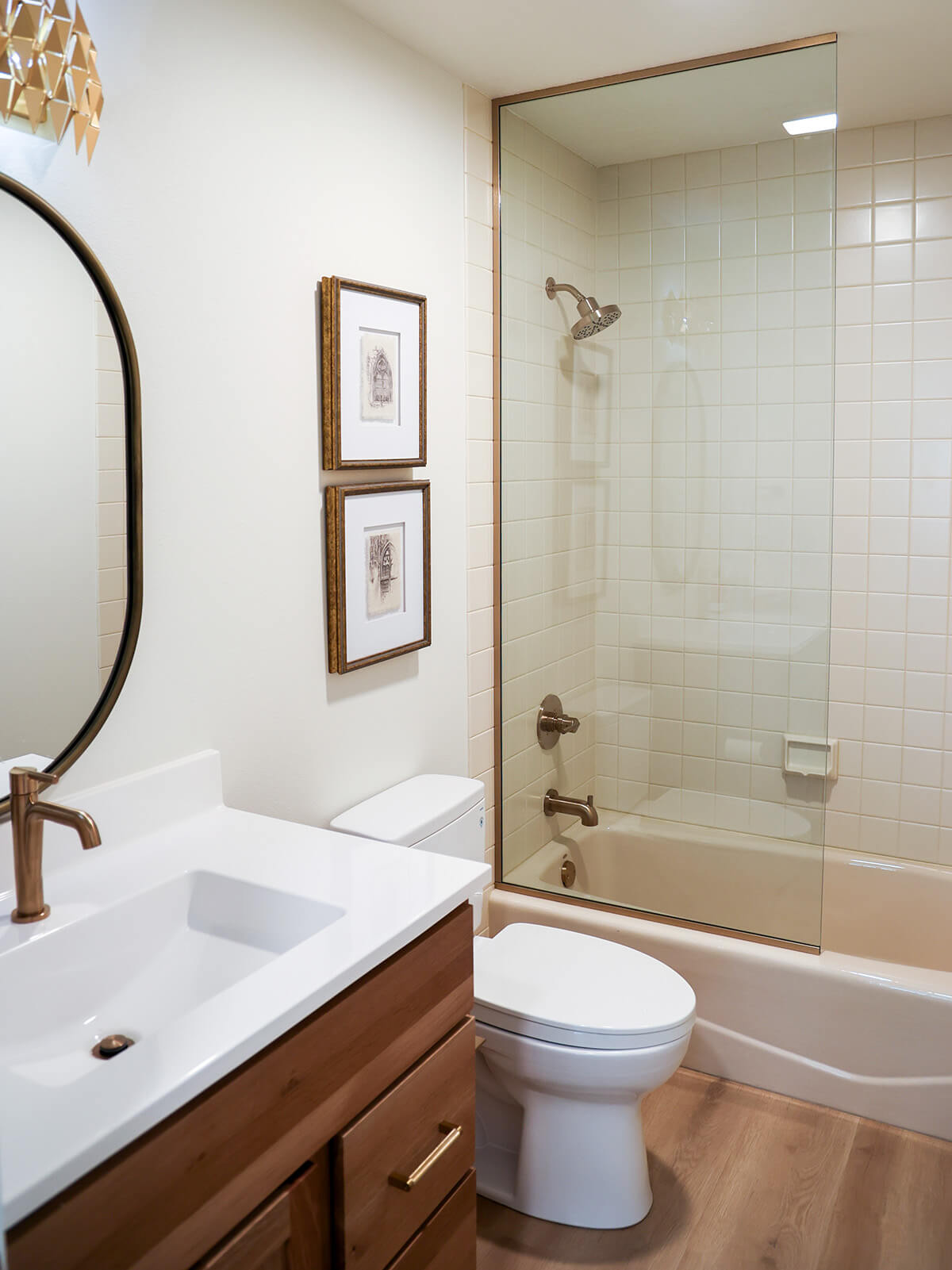 the-fairway-project-6 Elegant bathroom with warm brown cabinetry and a large mirror and bronze accents