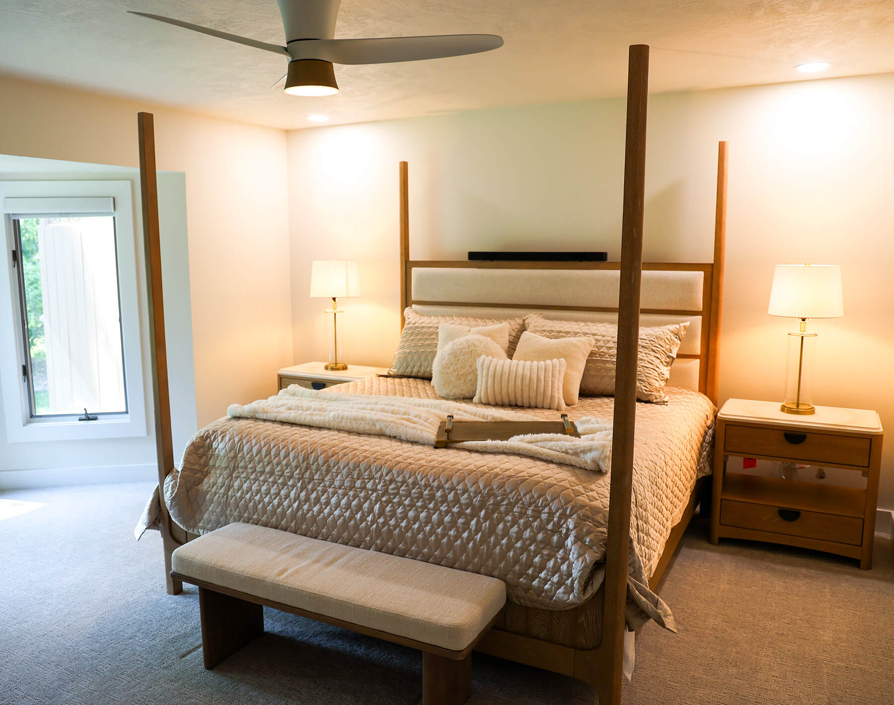 the-fairway-project-9 Light wood four-post bed frame with matching bedside tables and elegant brass-accented table lamps