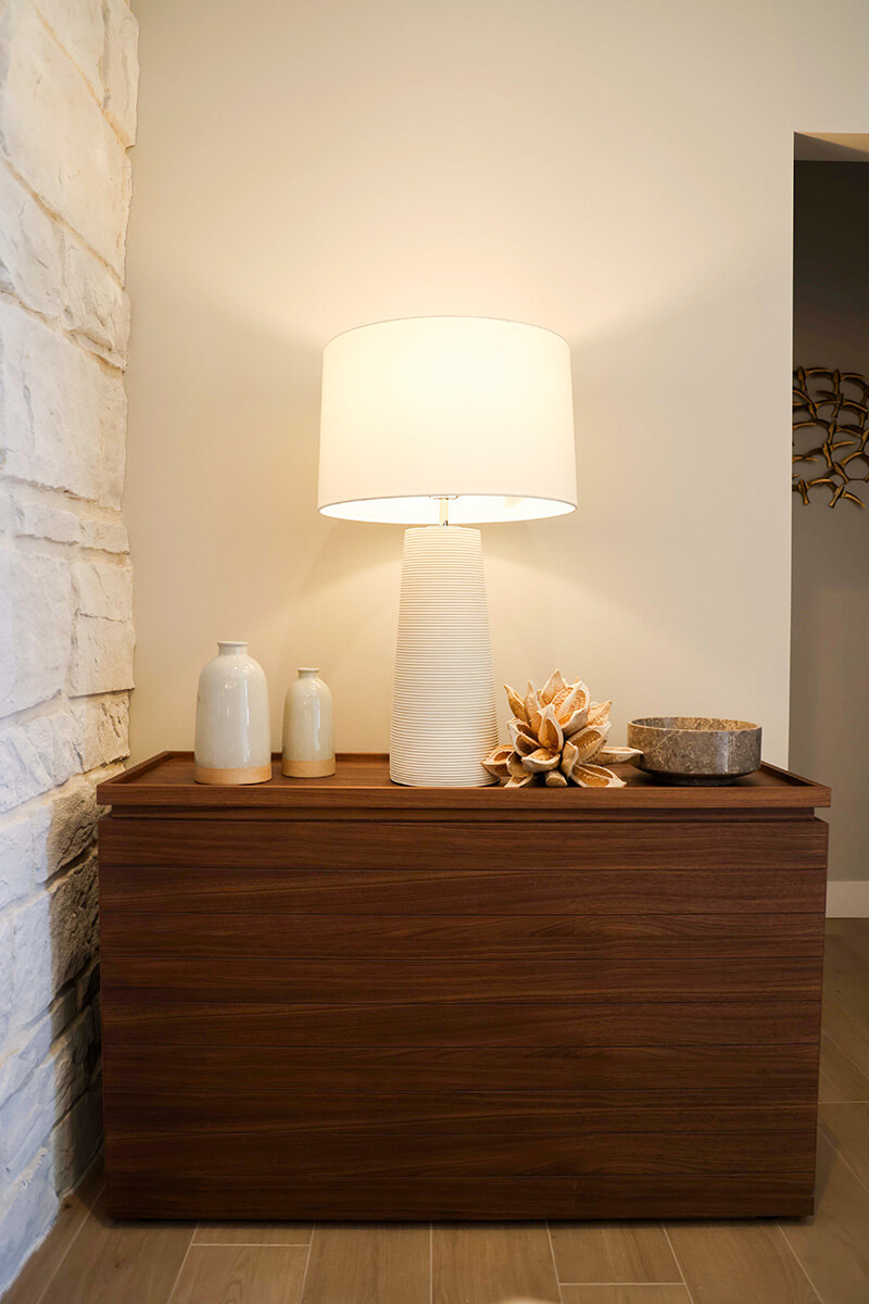 companion-project-3 Wood console table styled with a table lamp, ceramic decor, and natural accents