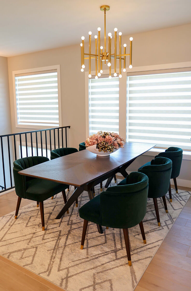 companion-project-9 Dining area with a wood table, upholstered chairs, floral centerpiece, and brass chandelier