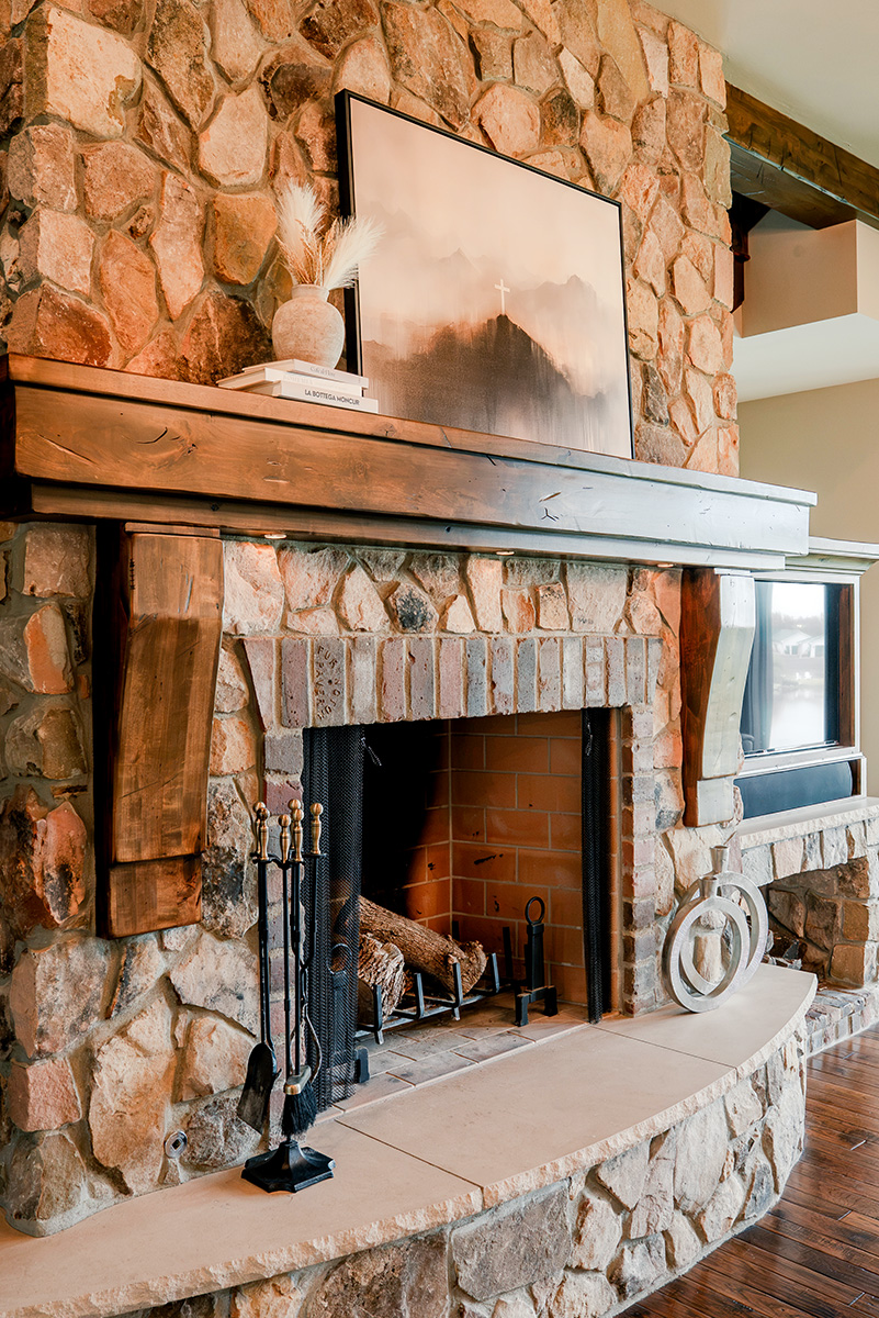 hearth-project-add-4 Stone fireplace with wood mantel, television, and built-in shelving