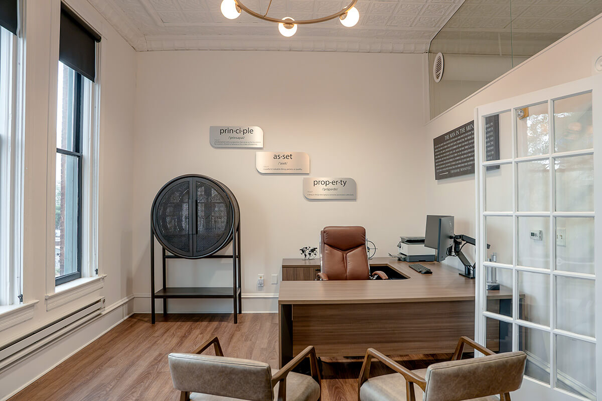 principle-properties-project-6 Modern office meeting area with a wood conference table and contemporary lighting