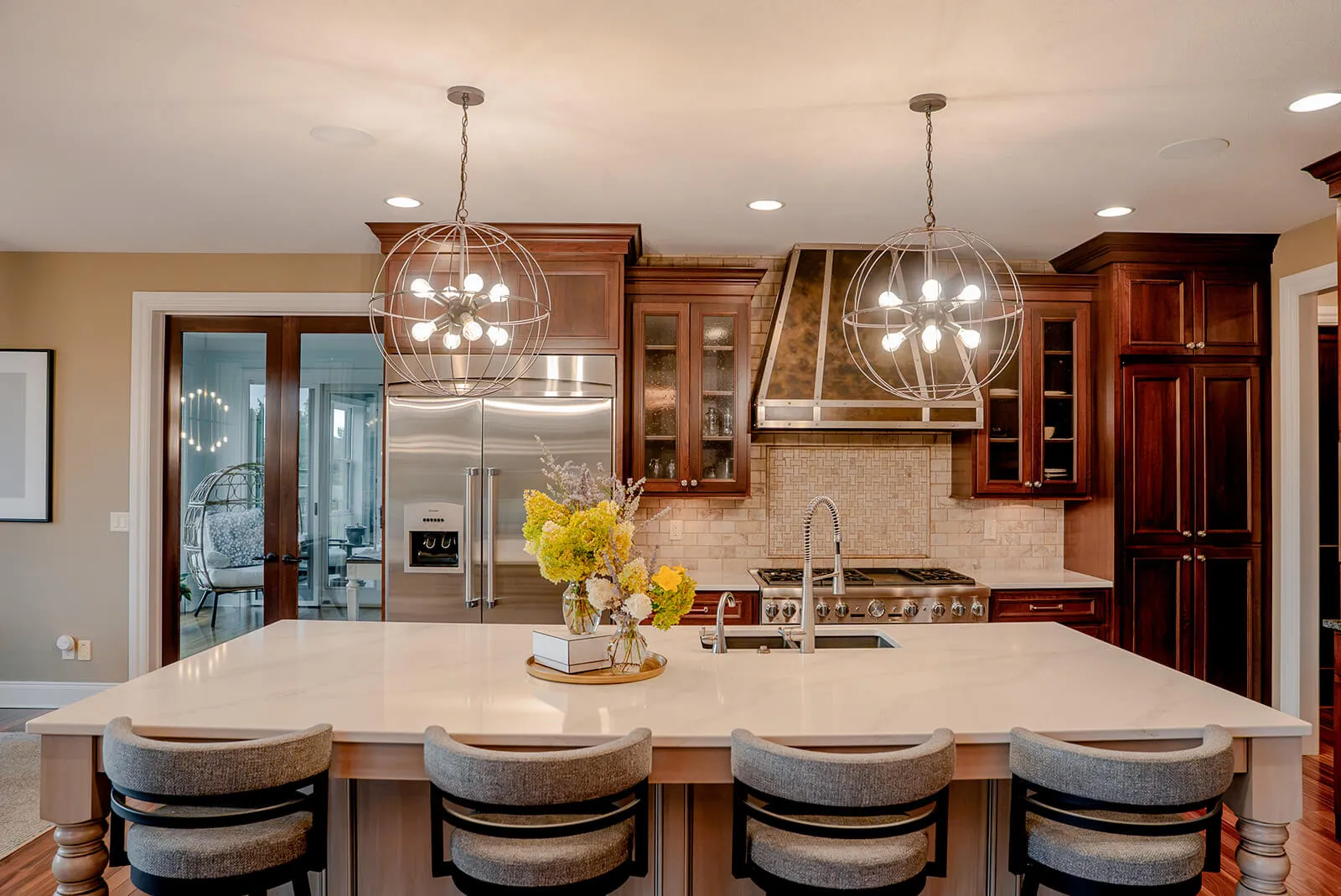 taylor-jane-project-46 Bright kitchen and dining space with wood cabinetry, pendant lighting, and warm natural finishes