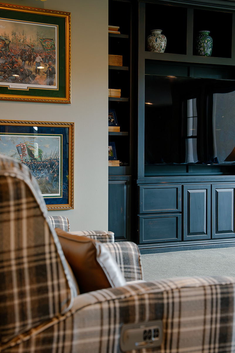 taylor-jane-project-49 Plaid armchair beside dark built-in cabinetry in a traditional living room