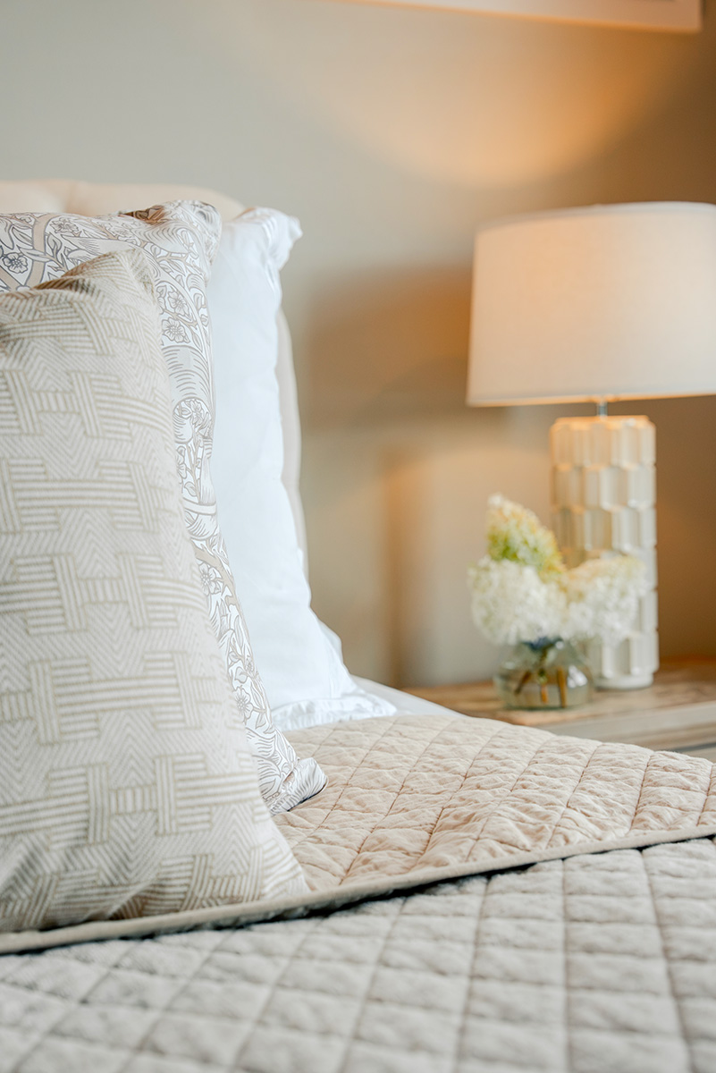 taylor-jane-project-50 Layered bedding and decorative lamp in a softly styled bedroom